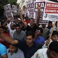 Immigrants shout slogans during an anti-racism rally in Nikaia