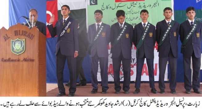 Principal taking oath from headboy and his team